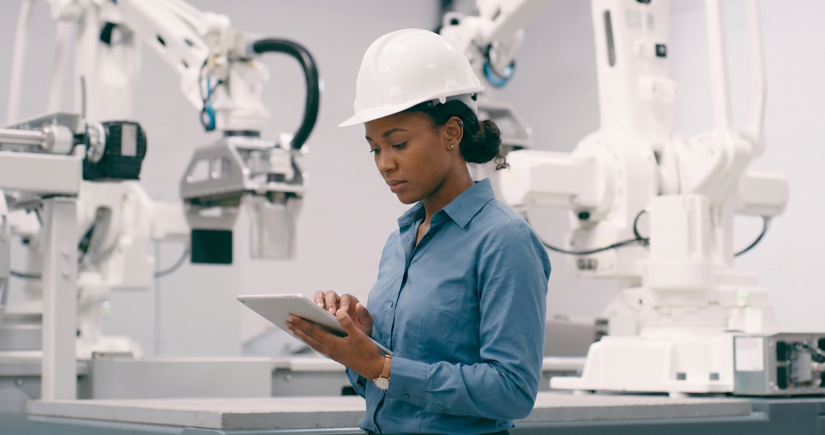 Engineer using a tablet in an automated factory